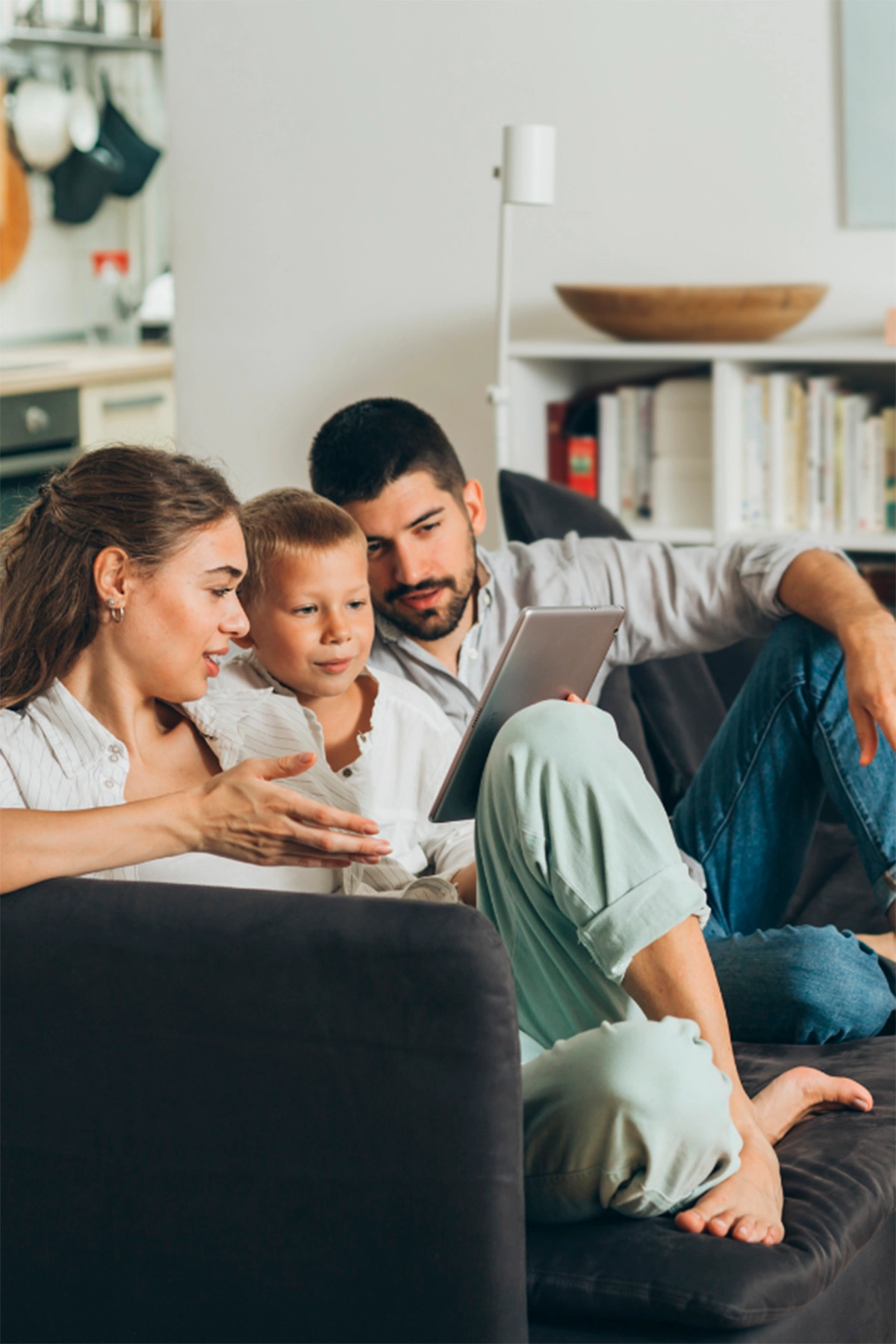 Family using a tablet to browse online with S-AGENT high-speed connection.